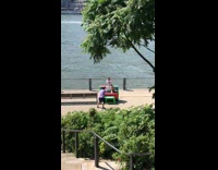 Girl sitting on green piano dances 