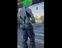 Model wears puffy black pants with pink and green 