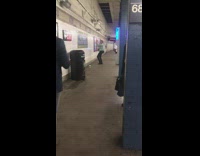 Guy blue shirt black satchel practicing fighting subway platform