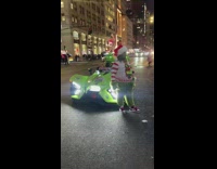 Grinch poses on sports car 