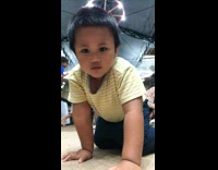 Kid Blocks Camera as Man Stares at Him