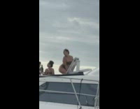 Man films women taking photos on yacht 