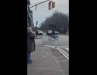 Man ride bike balance TV on head