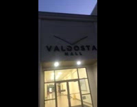 Kid throws a piece of bean burrito at Valdosta Hall sign