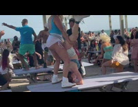 Woman twerks upside down on a table