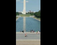 Girl sit ground red bra Lincoln memorial