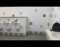 Blue shirt guy jumps parkours bathroom wall