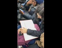 Guy reads a book chapter about child pornography on the subway train