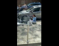 Woman Eats Takeout Next to Trash 