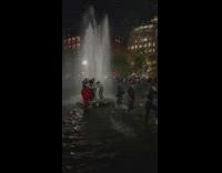 Group of People Run Toward Fountain Water Center 