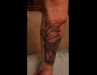 Arm tattoo with wolf and two pups