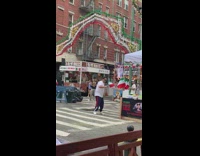 Man on street dances with small italian flag