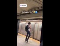 Man dance in subway while train pass by