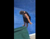 Woman tries to walk up empty slipper swimming pool and falls to the bottom
