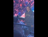 Man jacket hoodie poses on the balcony