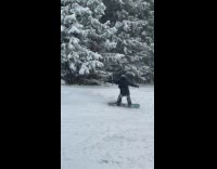 Guy snowboarding does jump trick falls down