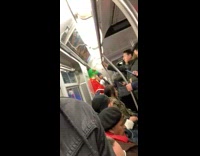Man on subway train wearing frog mask with red tuxedo