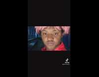 Guy with pink hair cosplays anime 