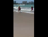 Woman hat pink bikini hold coconut beach