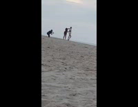 Red bathing suit girl helps friend pose