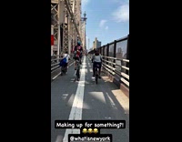 Guy rides tall bike at Queensboro Bridge