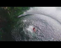 Shirtless guy backflip wood platform lake water