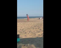 Woman red beach dress dance in the middle of the beach