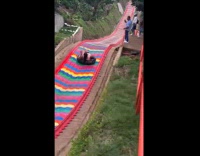 Woman tries rainbow slide hits trampoline hard