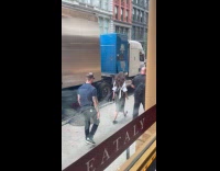 Anne Hathaway waves outside her rental truck
