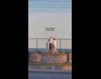 Elderly couple dance through sunset at street