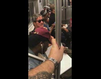 man in glasses picks at beard hair