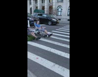 Guys ride lawn chairs on electric skateboards