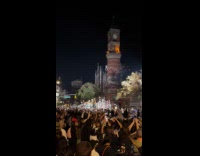 Marching tall skeletons Halloween parade street night