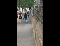 Yellow shirt blue overalls girl hangs wall 