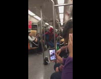 Guy wearing spiderman costume dances on subway 