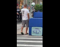 Guy shares cigarette with alien on street