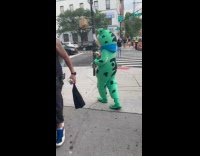 People greet person wear frog costume street