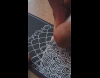 Gel pen art with white ink on black piece of paper 
