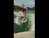 Guy brown dog ride white surfboard boat