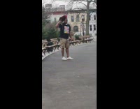 Collab WINY - Man black shirt Walks Pet Rooster on Shoulder at Park