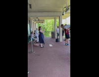 Guy carries lady on his shoulder with her legs up for photo