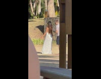Man film behind woman white dress run