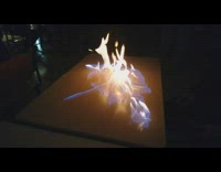 Guy uses match lights table on fire 