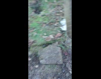 Person break ice formed from bucket on ground