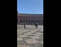 Woman in brown jacket tiktok dance at the park