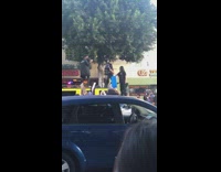 Two girls dance on yellow jeep protest 