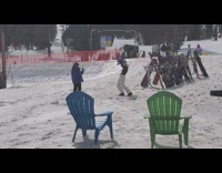 Girl holds snowboard over head white pants