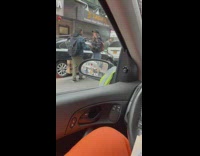 Man and woman take turns in the middle of the street