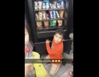 Little kid sticks hand in vending machine 