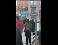 Man lifted to look inside trash can